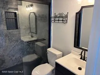 a bathroom with a sink toilet and shower