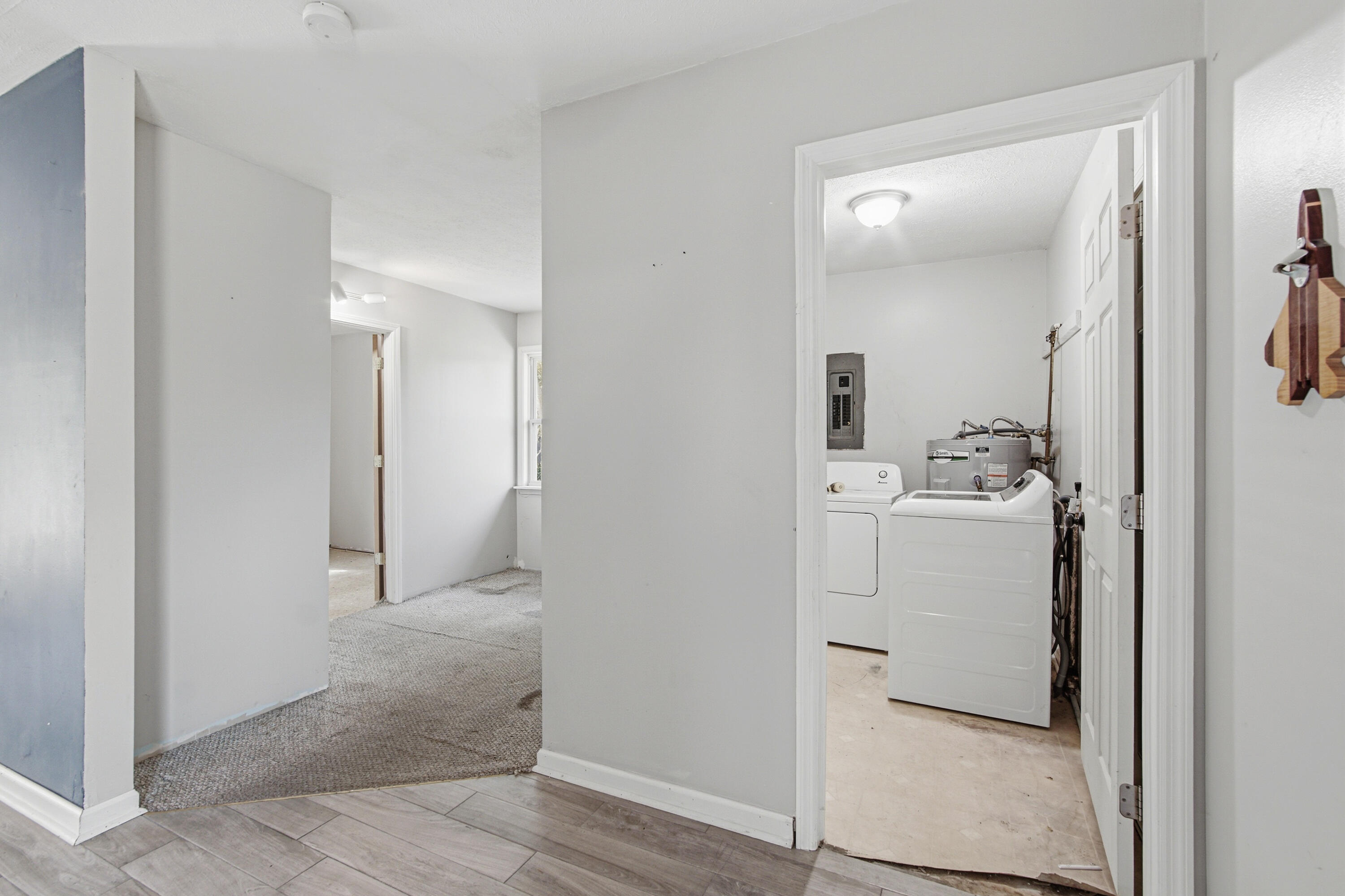 1247 Amherst Road Panama City, FL 32405 - Photo 12 of 28 a view of a hallway to a room with a washer and dryer