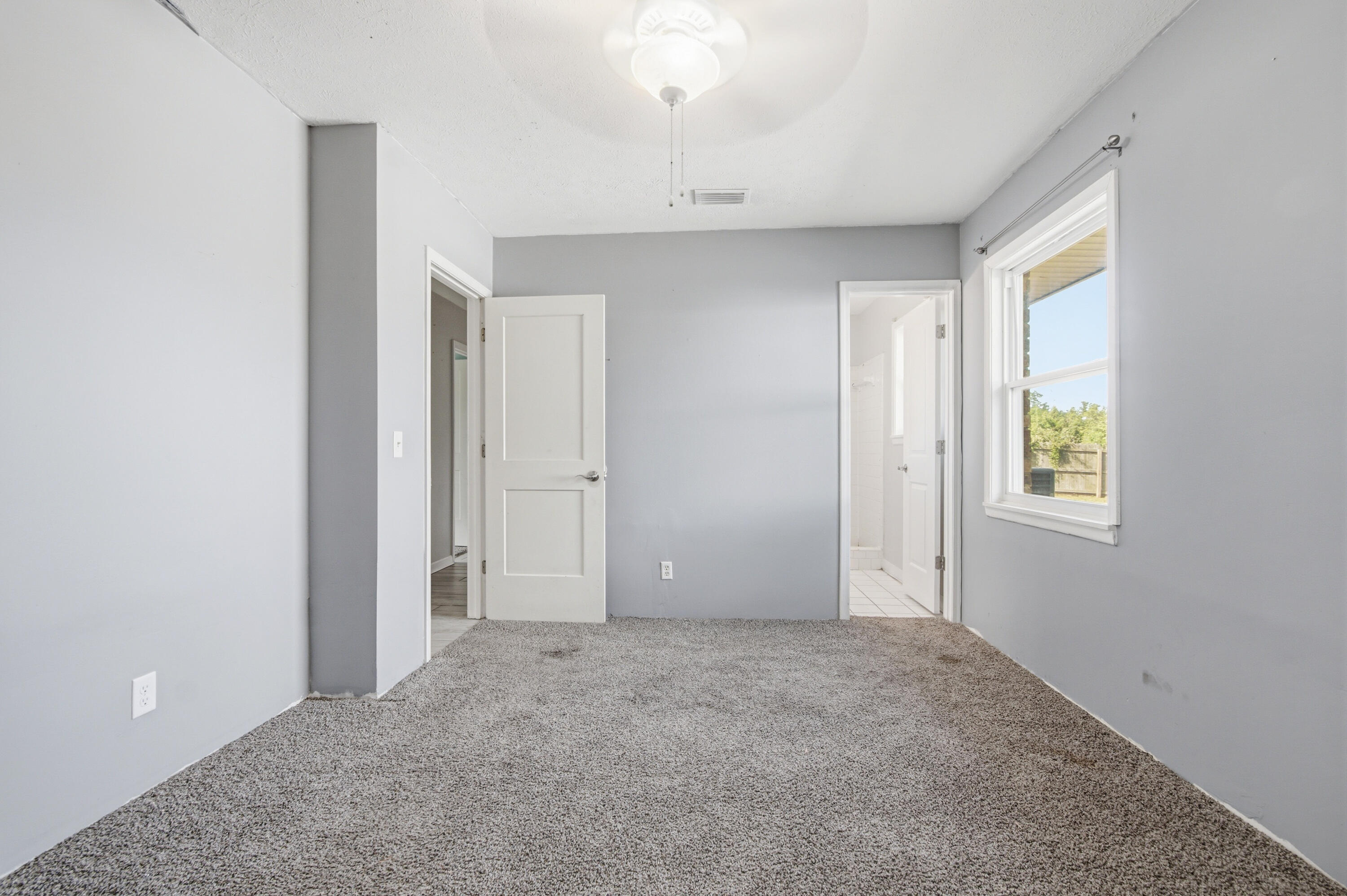 1247 Amherst Road Panama City, FL 32405 - Photo 15 of 28 an empty room with windows and closet