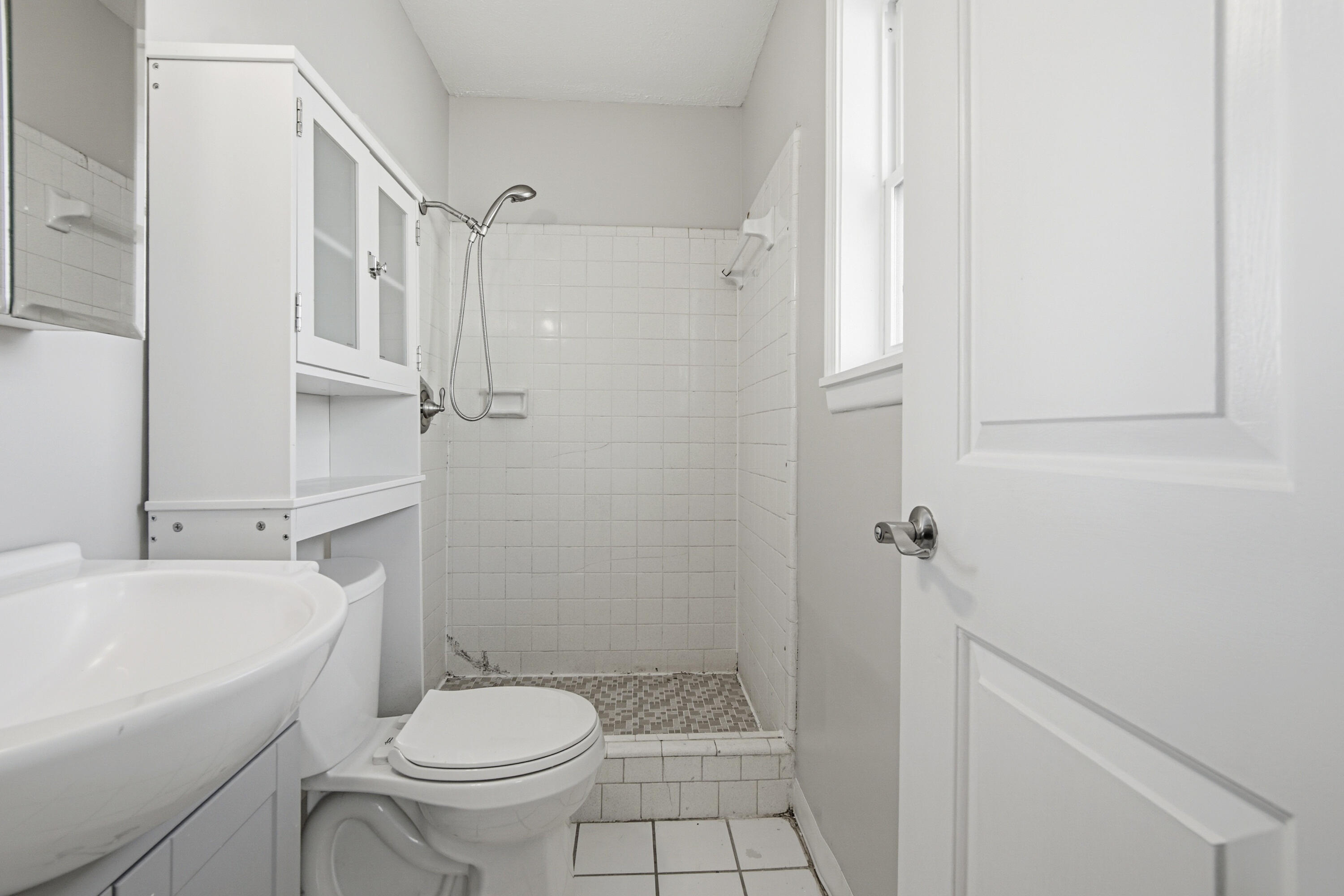 1247 Amherst Road Panama City, FL 32405 - Photo 16 of 28 a bathroom with a sink a toilet and shower
