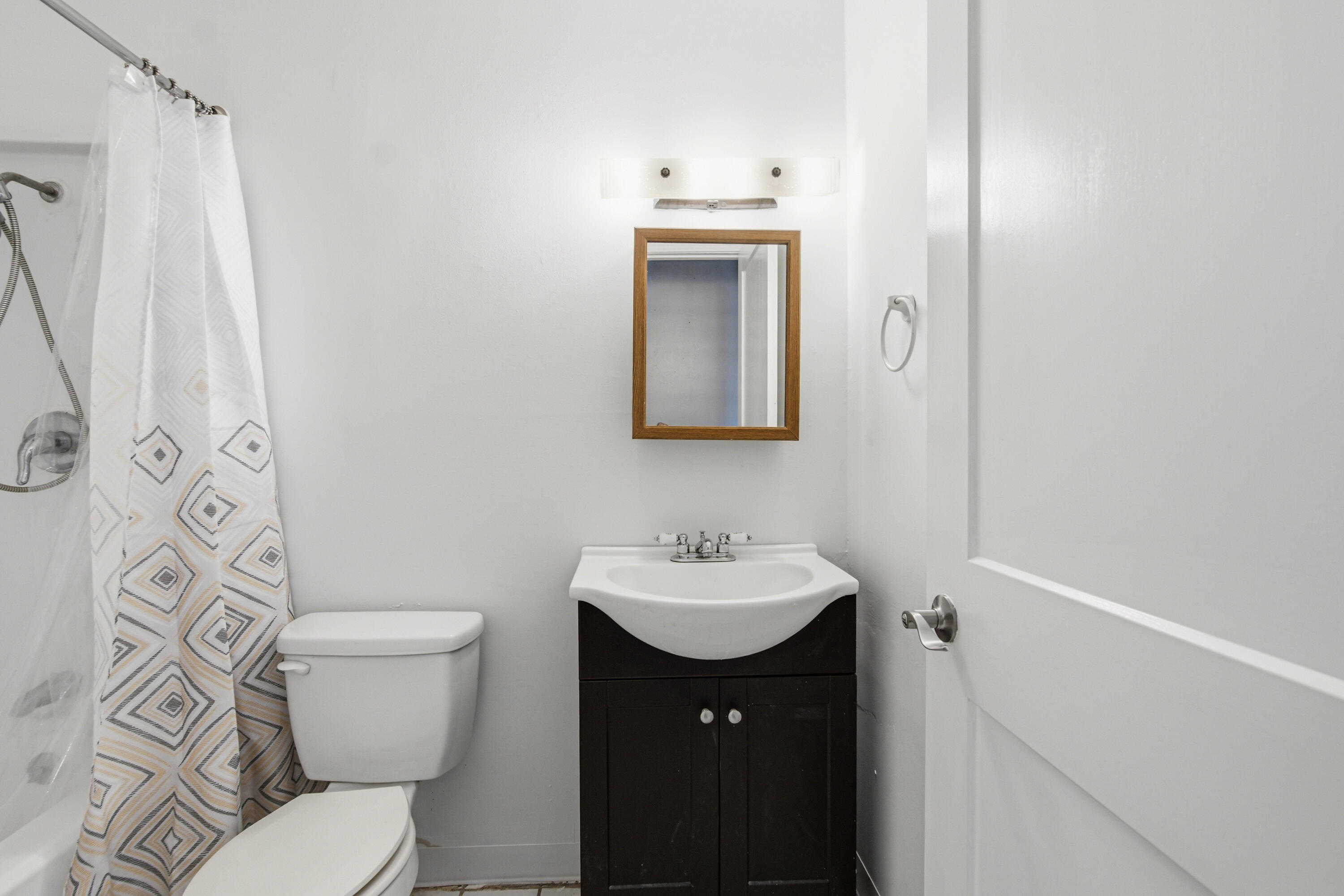 1247 Amherst Road Panama City, FL 32405 - Photo 21 of 28 a bathroom with a sink toilet and mirror