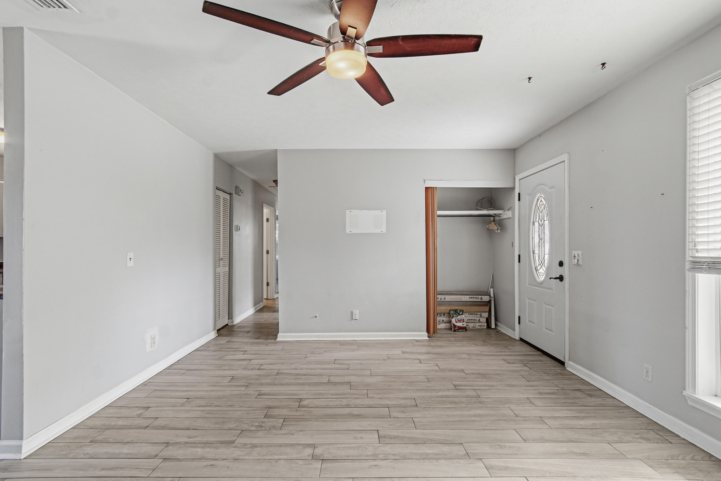 1247 Amherst Road Panama City, FL 32405 - Photo 4 of 28 wooden floor in an empty room with a window