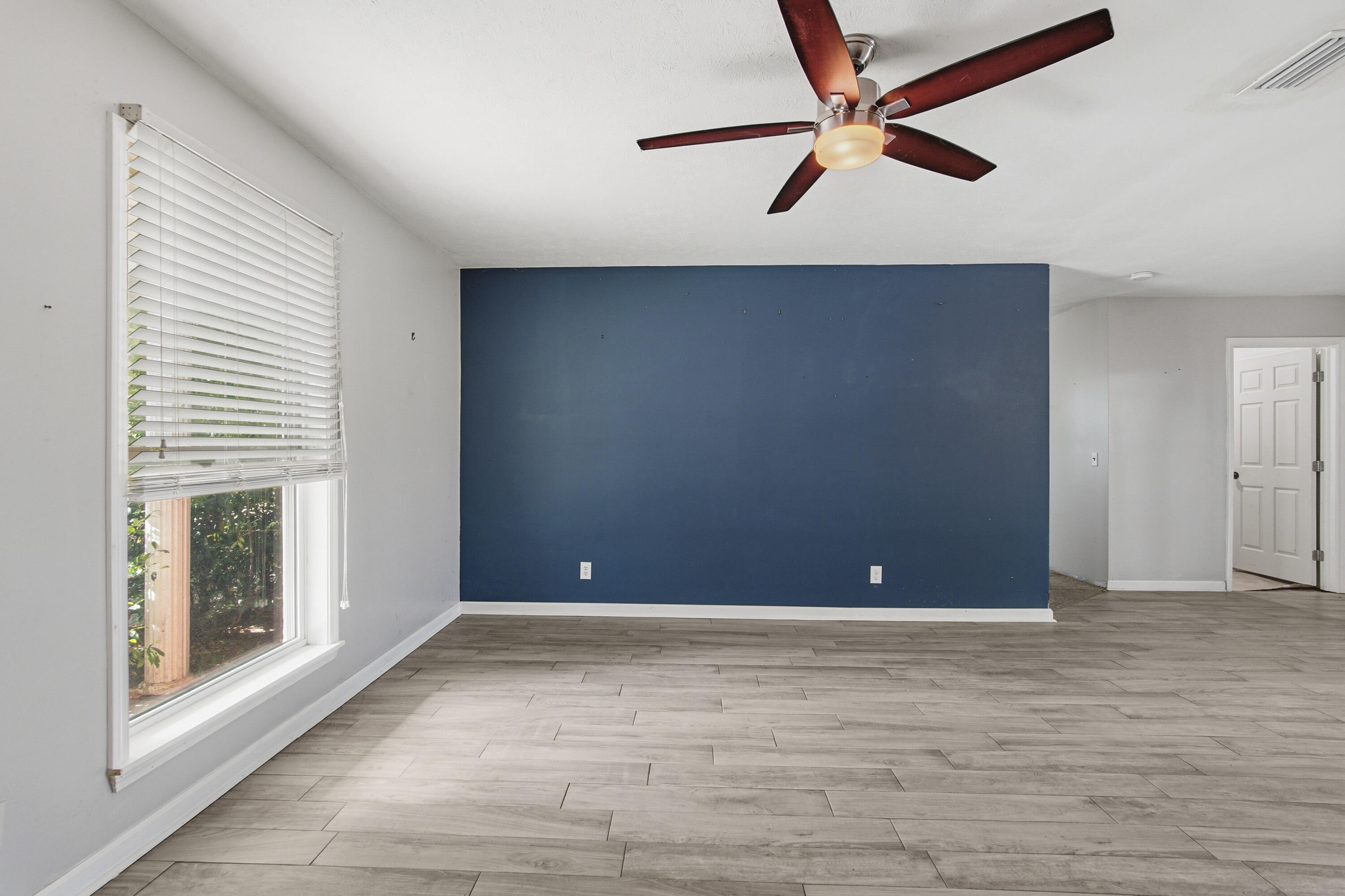 1247 Amherst Road Panama City, FL 32405 - Photo 5 of 28 a view of an empty room with window and a ceiling fan