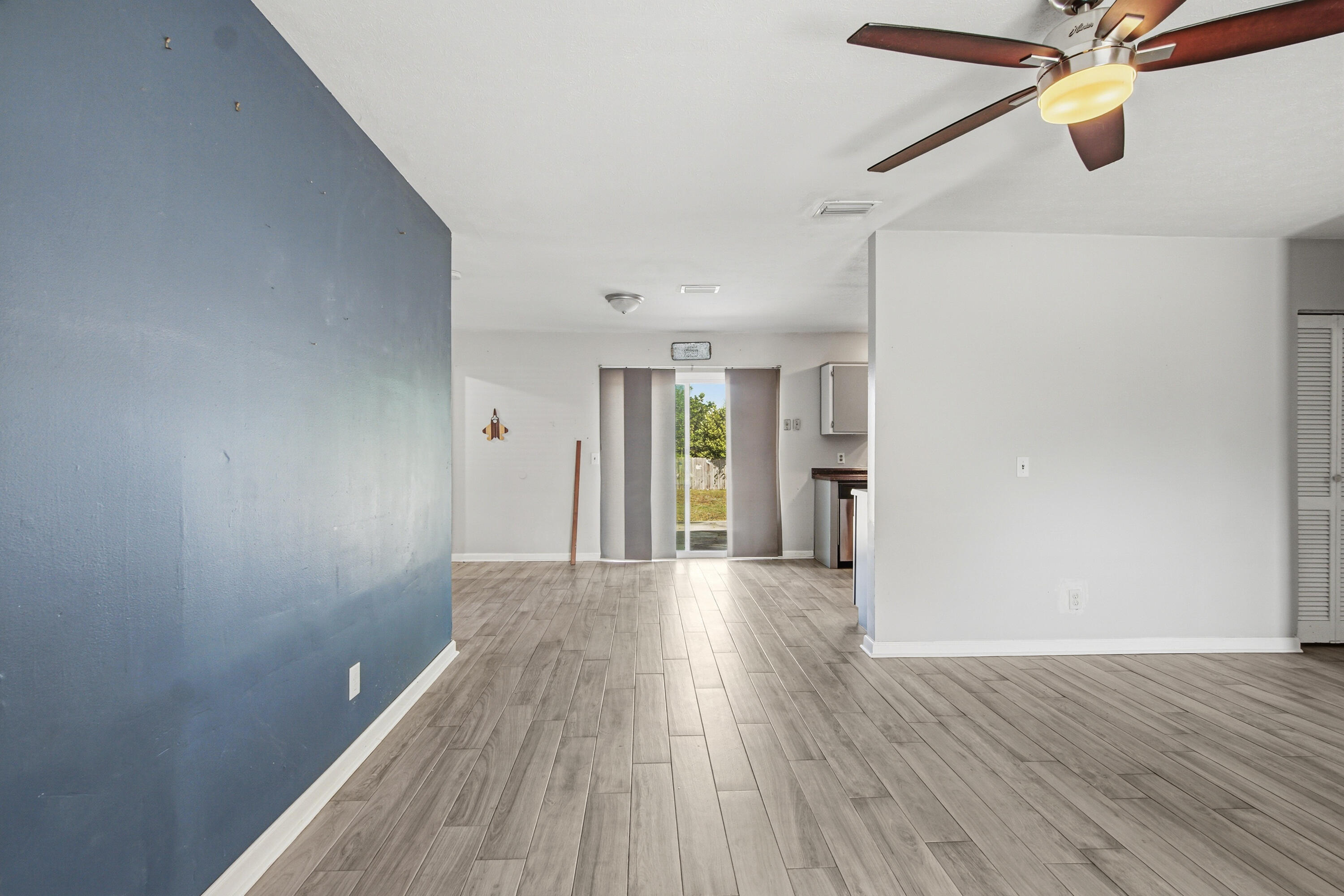 1247 Amherst Road Panama City, FL 32405 - Photo 7 of 28 a view of a big room with wooden floor and windows