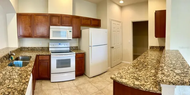 a kitchen with a stove and a refrigerator