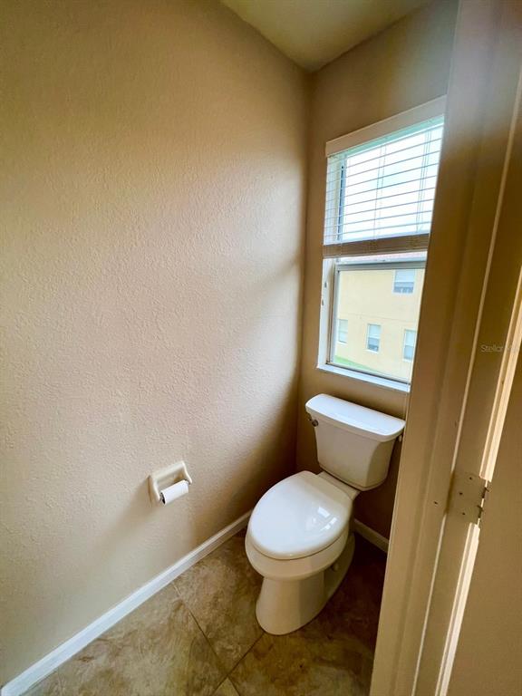 2992 Langdon Lane South Kissimmee, FL 34741 - Photo 20 of 39 a white toilet sitting next to a window