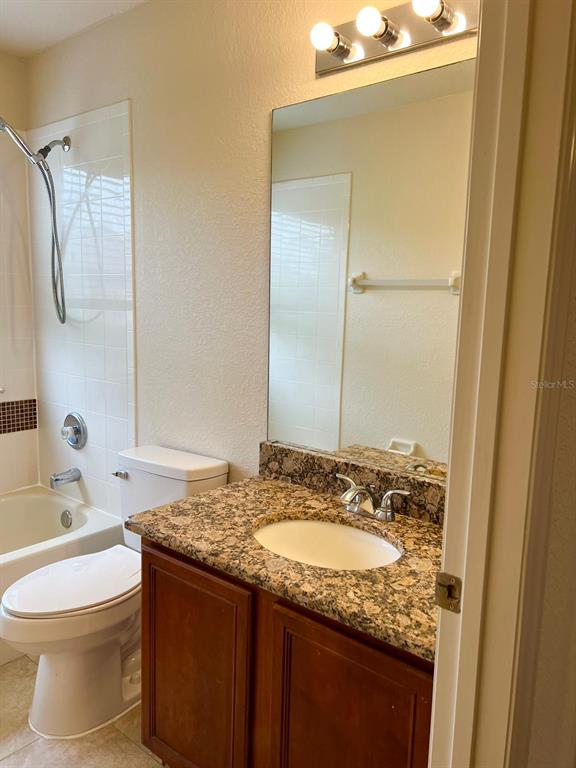 2992 Langdon Lane South Kissimmee, FL 34741 - Photo 22 of 39 a bathroom with a granite countertop sink toilet and shower