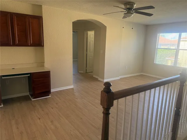a view of a hallway with entryway wooden floor and front door