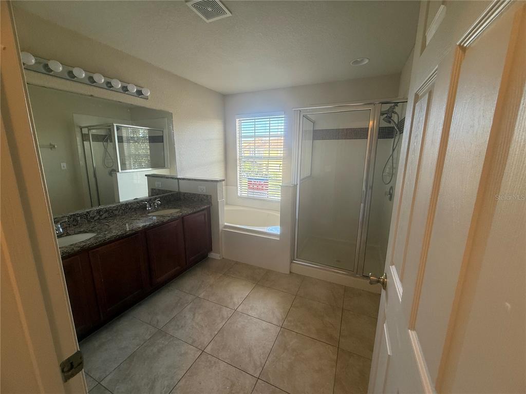 2992 Langdon Lane South Kissimmee, FL 34741 - Photo 34 of 39 a room with a granite countertop sink and a mirror