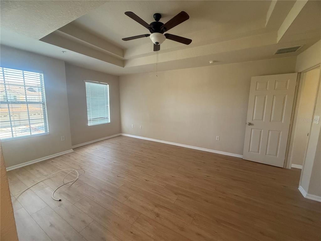 2992 Langdon Lane South Kissimmee, FL 34741 - Photo 35 of 39 wooden floor in an empty room with a window