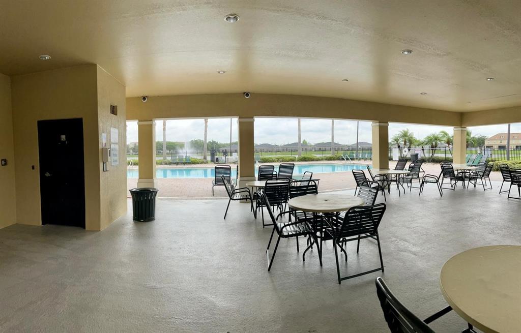 2992 Langdon Lane South Kissimmee, FL 34741 - Photo 4 of 39 an outdoor dining space with furniture and outdoor view