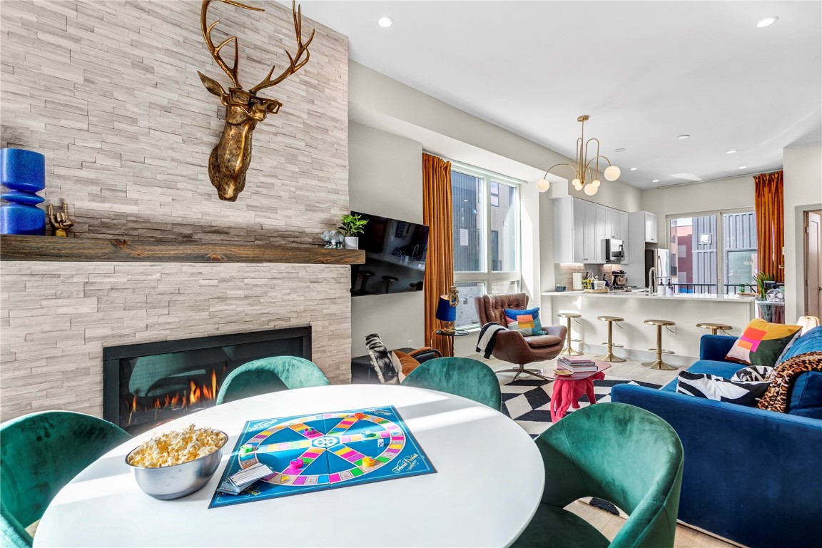 58 3rd Street, Unit D Silverthorne, CO 80498 - Photo 11 of 29 a living room with furniture a flat screen tv and a fireplace