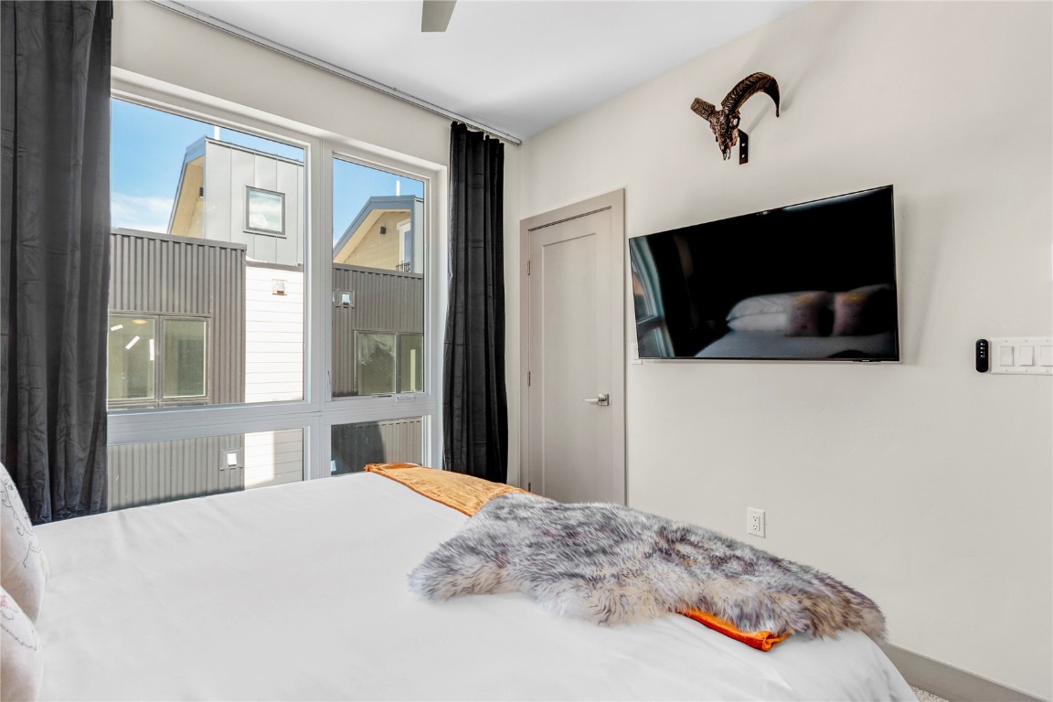 58 3rd Street, Unit D Silverthorne, CO 80498 - Photo 16 of 29 a bedroom with a bed and a flat screen tv