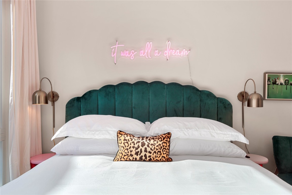 58 3rd Street, Unit D Silverthorne, CO 80498 - Photo 22 of 29 a bedroom with a bed and a chandelier