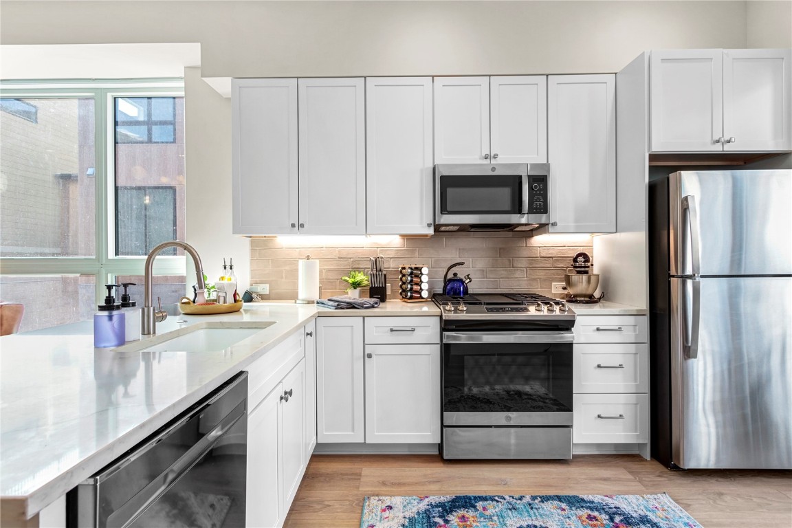 58 3rd Street, Unit D Silverthorne, CO 80498 - Photo 5 of 29 a kitchen with cabinets stainless steel appliances and a sink