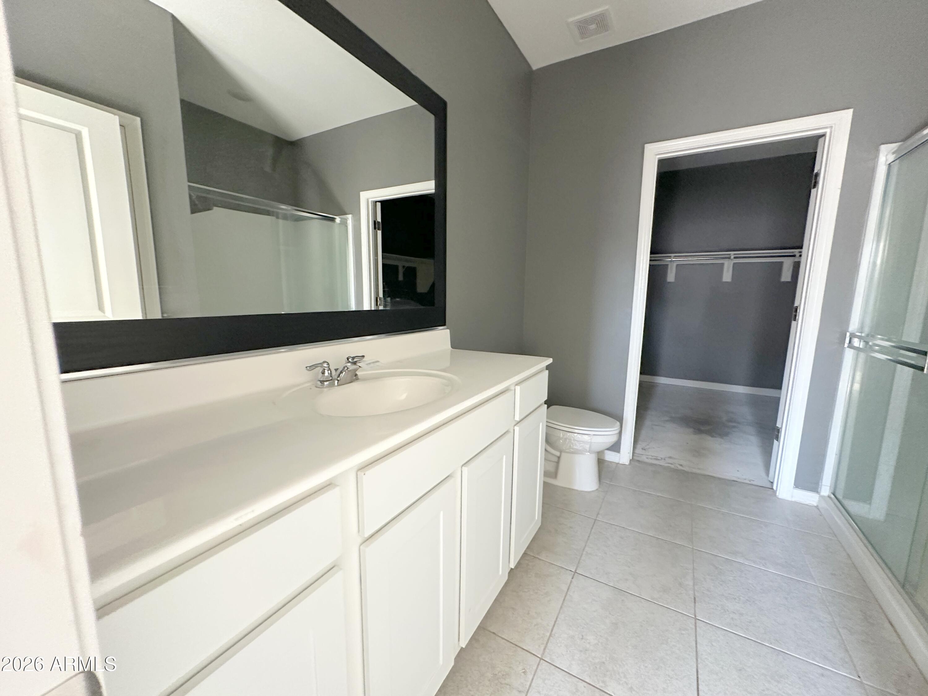 6085 East Athena Road Florence, AZ 85132 - Photo 11 of 21 a bathroom with a sink a toilet and a mirror