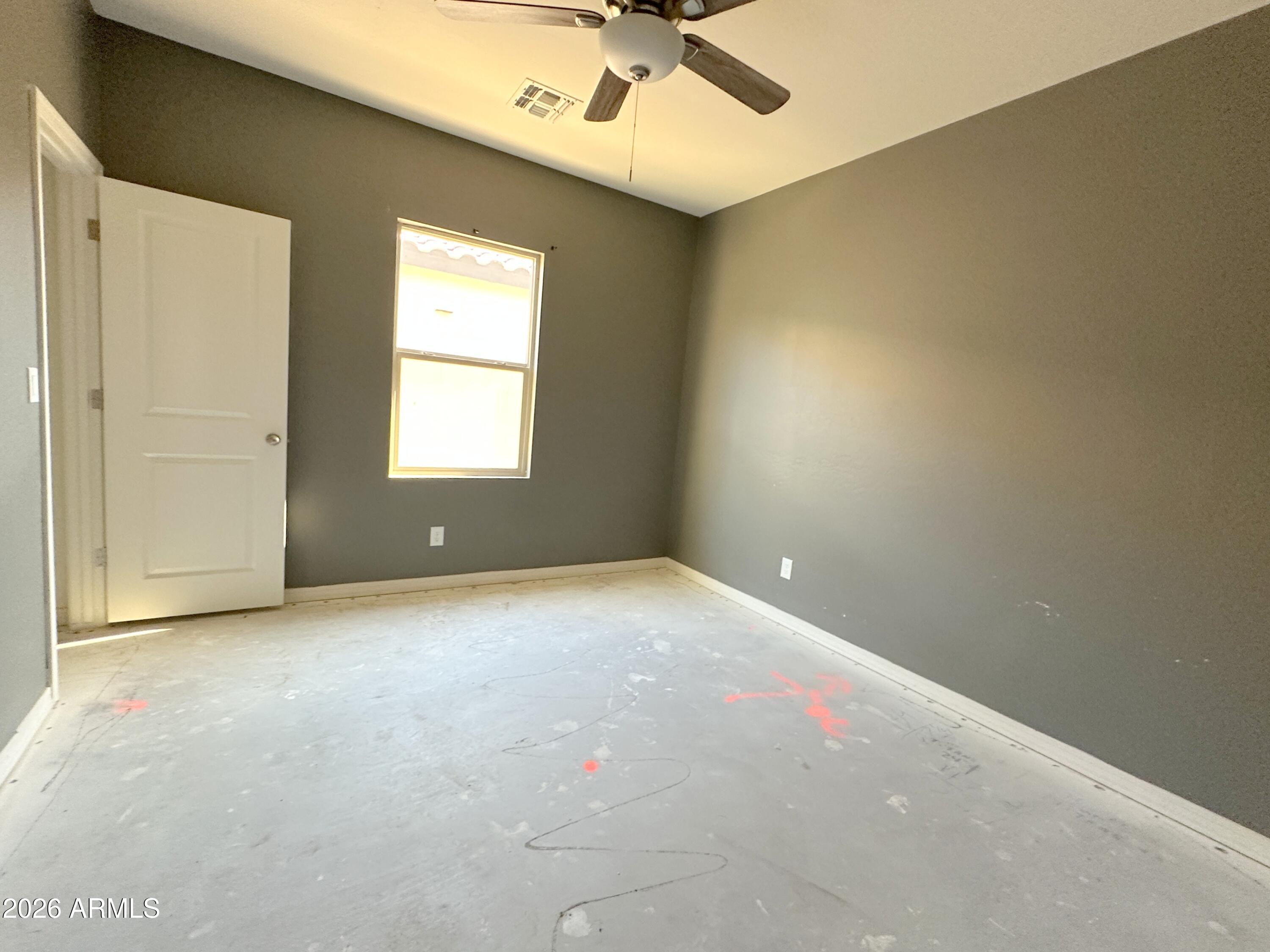 6085 East Athena Road Florence, AZ 85132 - Photo 13 of 21 an empty room with a window and a ceiling fan
