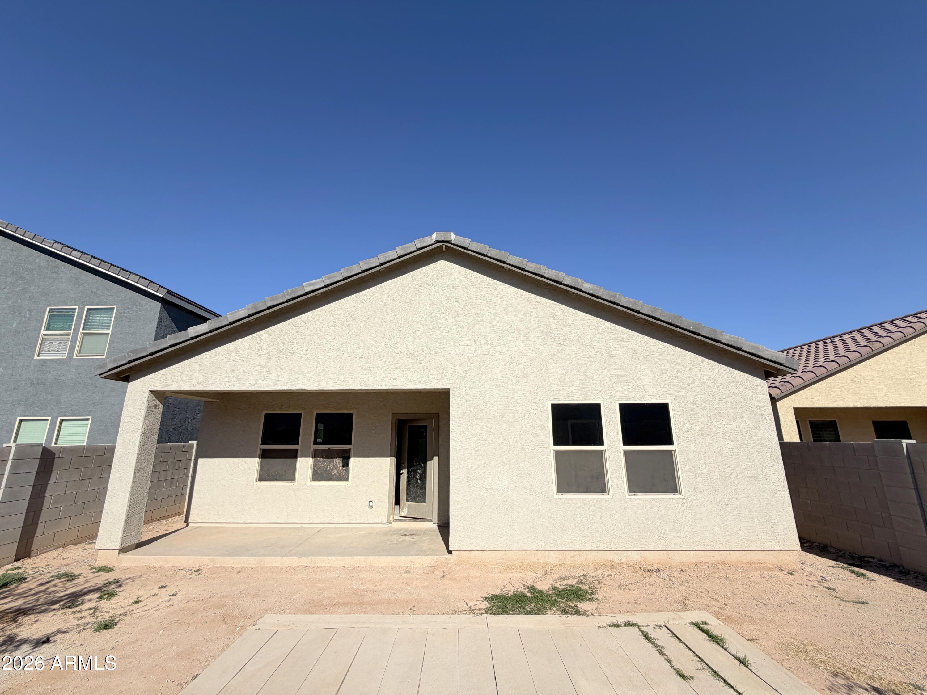 6085 East Athena Road Florence, AZ 85132 - Photo 18 of 21 a view of a house with wooden floor and fence