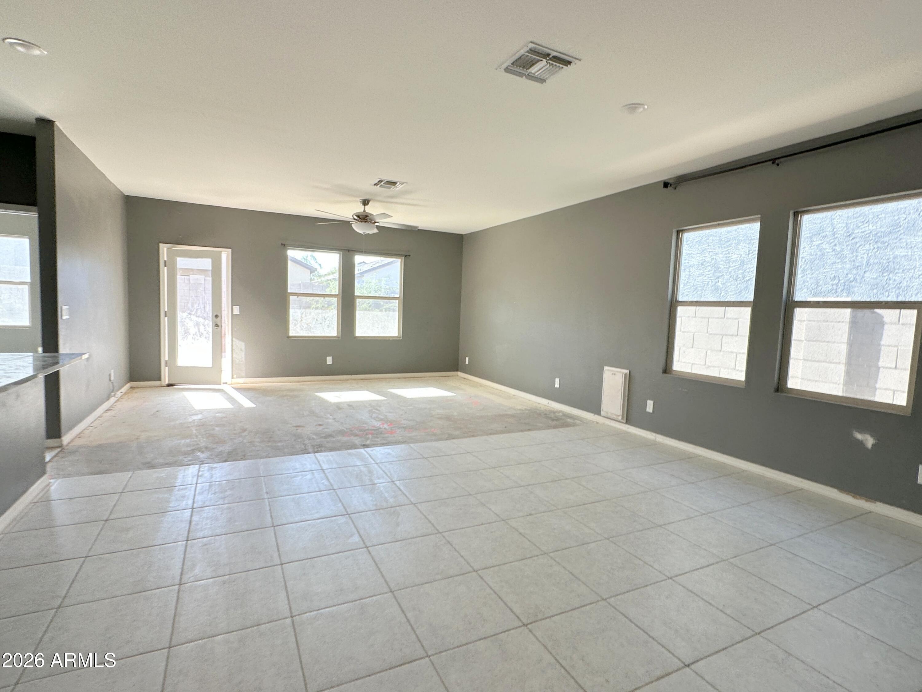 6085 East Athena Road Florence, AZ 85132 - Photo 6 of 21 a view of an empty room with window and wooden floor