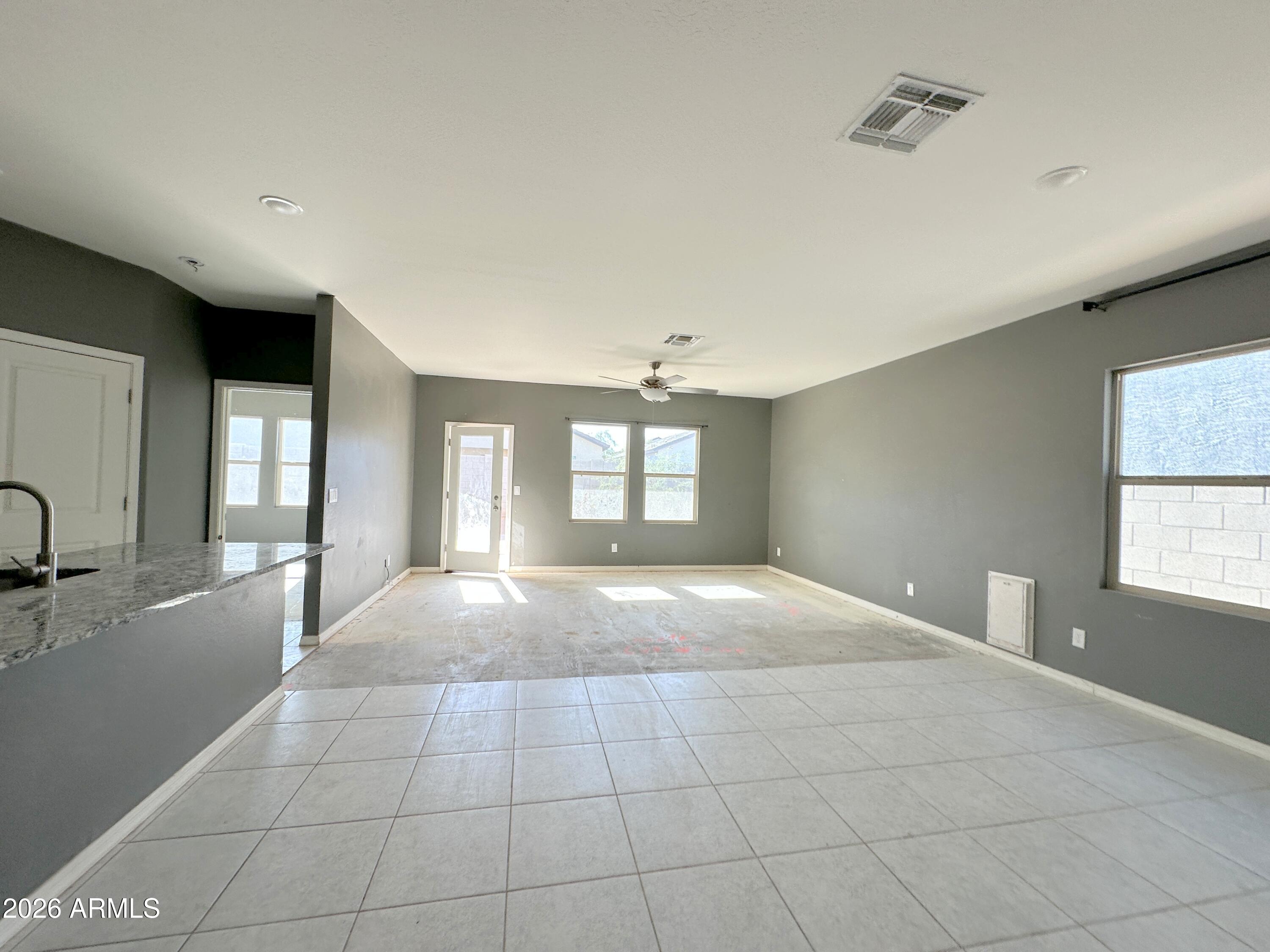6085 East Athena Road Florence, AZ 85132 - Photo 7 of 21 a view of an empty room with window and wooden floor