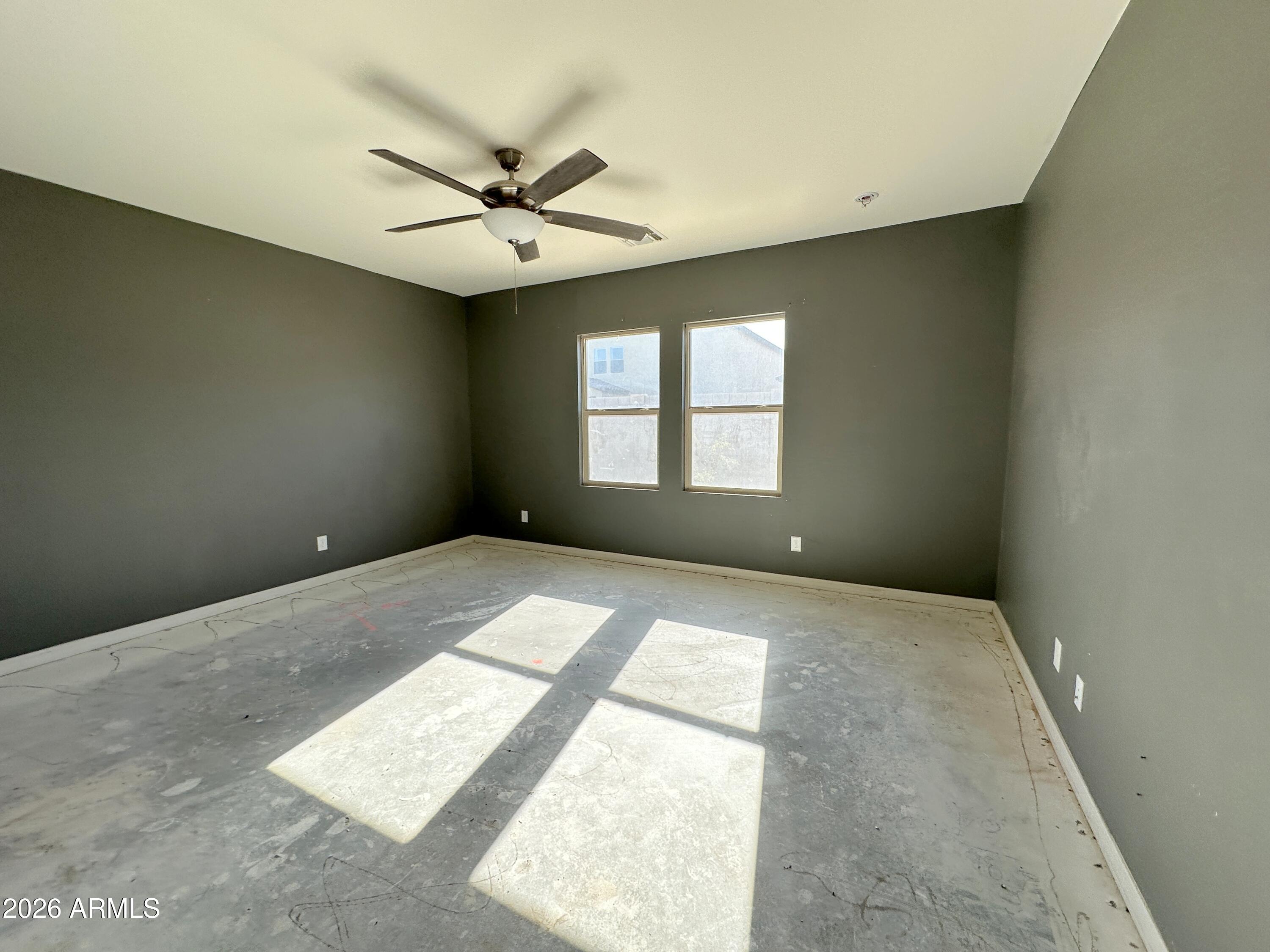 6085 East Athena Road Florence, AZ 85132 - Photo 10 of 21 an empty room with windows and fan