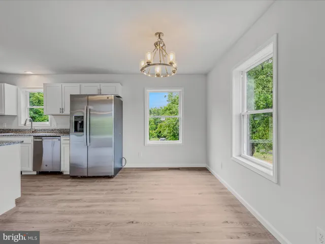 a view of a kitchen with a stove cabinets and a wooden floor