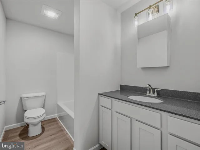 a white toilet sitting next to a bathroom sink