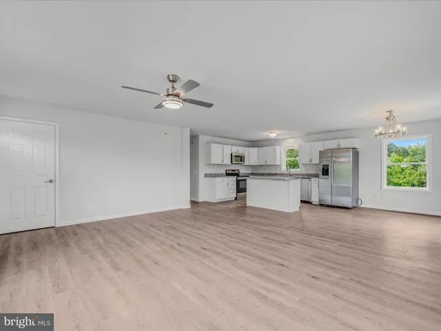 a view of a kitchen with a sink and a window