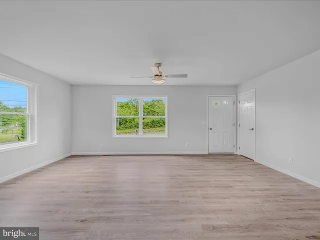 wooden floor in an empty room with a window
