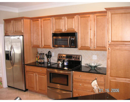 68 Peach Hill Road Berlin, MA 01503 - Photo 3 of 14 a kitchen with granite countertop a stove top oven microwave and refrigerator