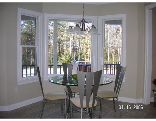 68 Peach Hill Road Berlin, MA 01503 - Photo 6 of 14 a view of a dining room with furniture a chandelier and wooden floor