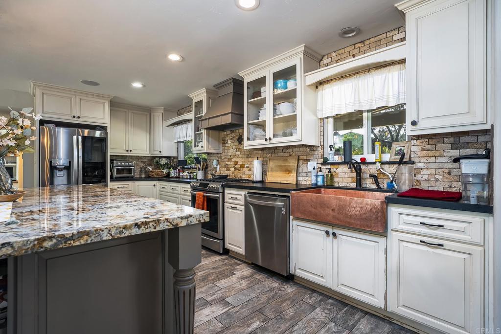 2430 Geyer Lane Alpine, CA 91901 - Photo 12 of 60 a kitchen with stainless steel appliances granite countertop a stove sink and cabinets