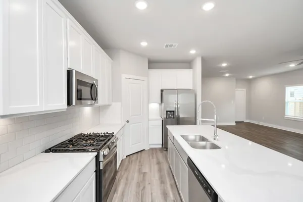 a kitchen with a sink a stove and refrigerator