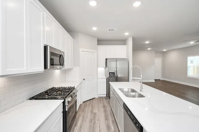 a kitchen with a sink a stove and refrigerator