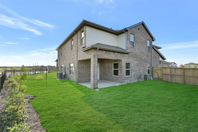 a view of a house with a yard and deck