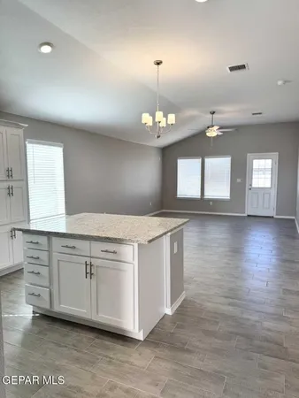 a view of a kitchen sink and chandelier