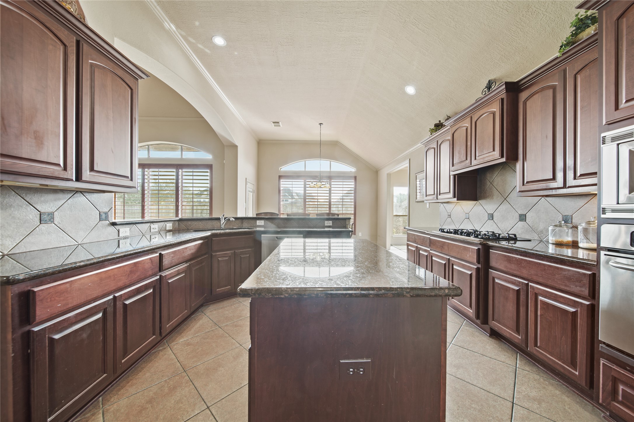 3414 Rue Orleans Missouri City, TX 77459 - Photo 18 of 46 a large kitchen with stainless steel appliances granite countertop a stove and a sink
