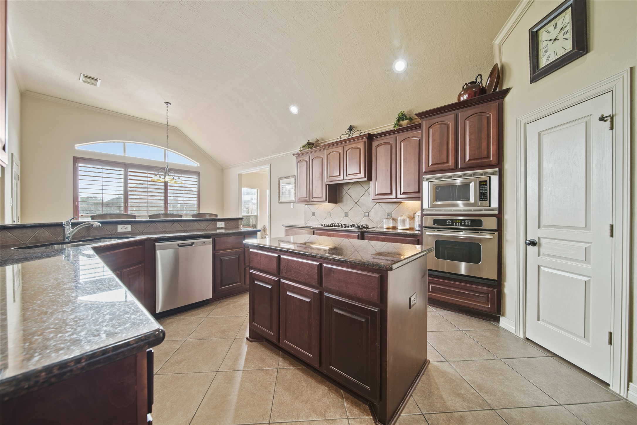 3414 Rue Orleans Missouri City, TX 77459 - Photo 19 of 46 a kitchen with stainless steel appliances granite countertop a stove top oven and cabinets