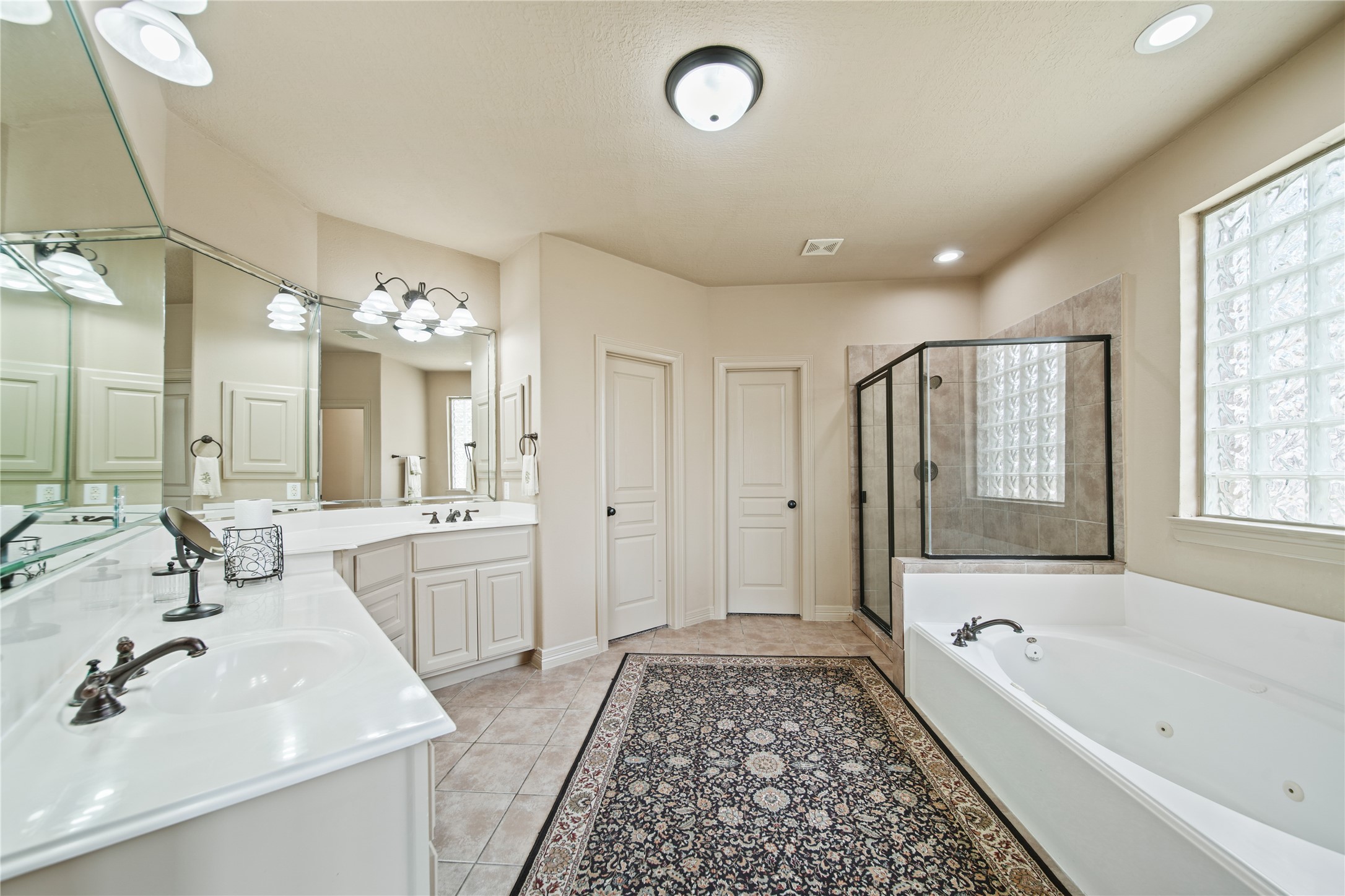 3414 Rue Orleans Missouri City, TX 77459 - Photo 30 of 46 a spacious bathroom with a double vanity sink a mirror a bathtub and shower