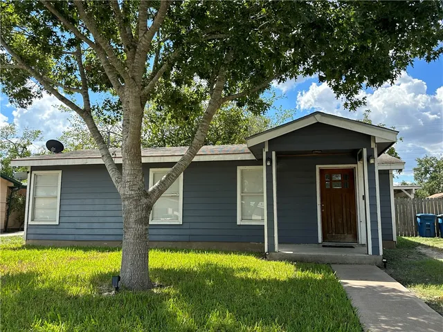 a house with a tree in front of it