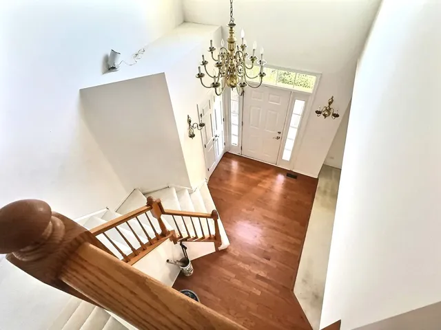 a view of a living room with furniture and a chandelier