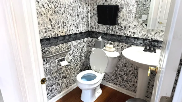 a bathroom with a toilet and a shower curtain