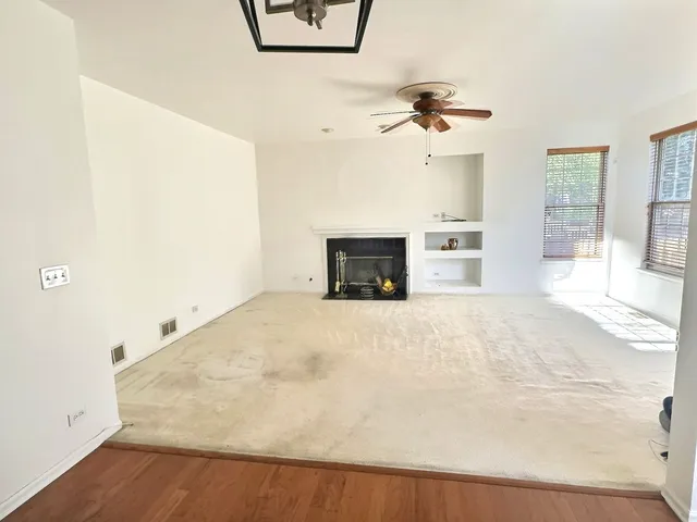a view of a livingroom with a furniture and a ceiling fan