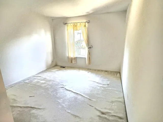 an empty room with a windows