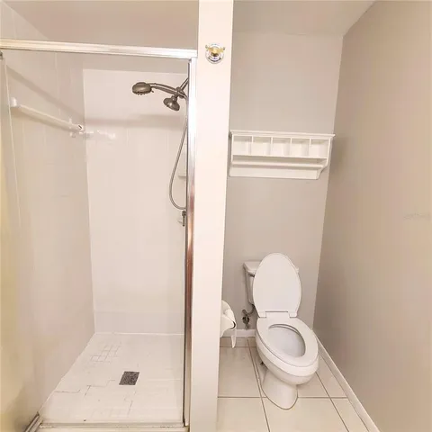 a bathroom with a toilet and a shower
