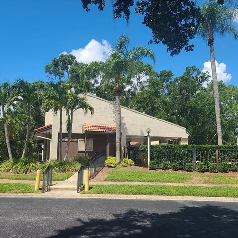a view of a house with a yard and potted plants
