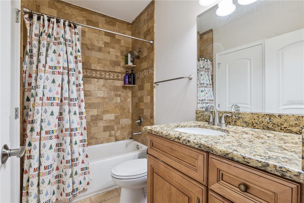 345 Cypress Isles Road Osteen, FL 32764 - Photo 21 of 41 a bathroom with a granite countertop sink a toilet and shower