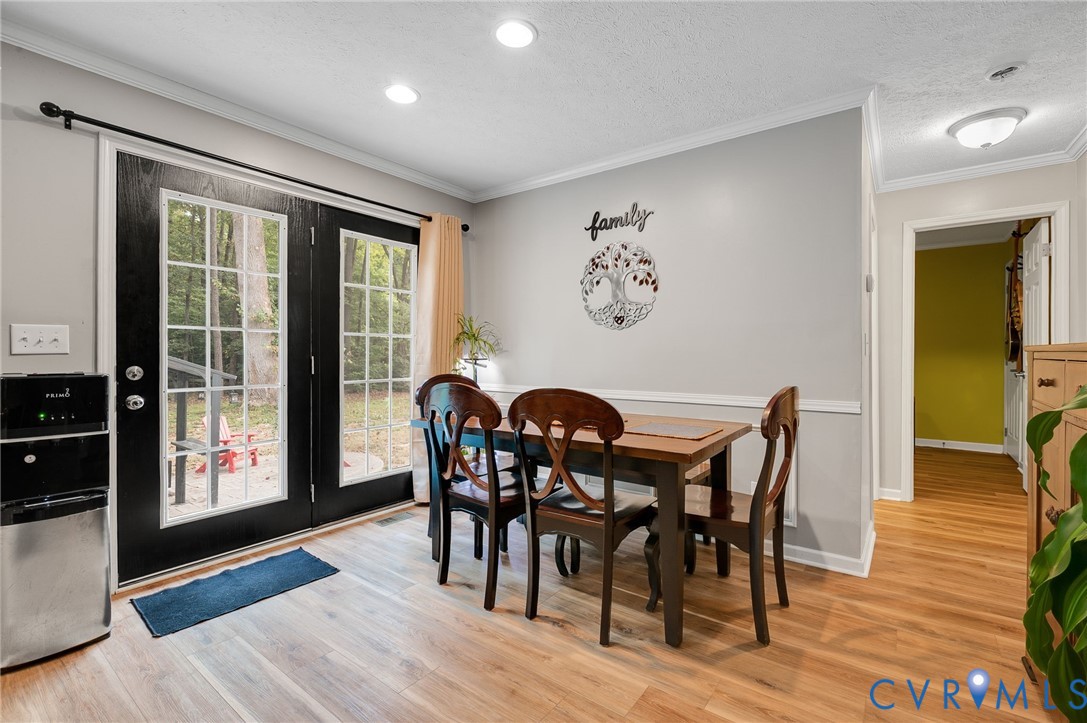 123 Riverview Road Stevensville, VA 23161 - Photo 10 of 28 Wood-finish flooring, two-tone wall paint, crown m