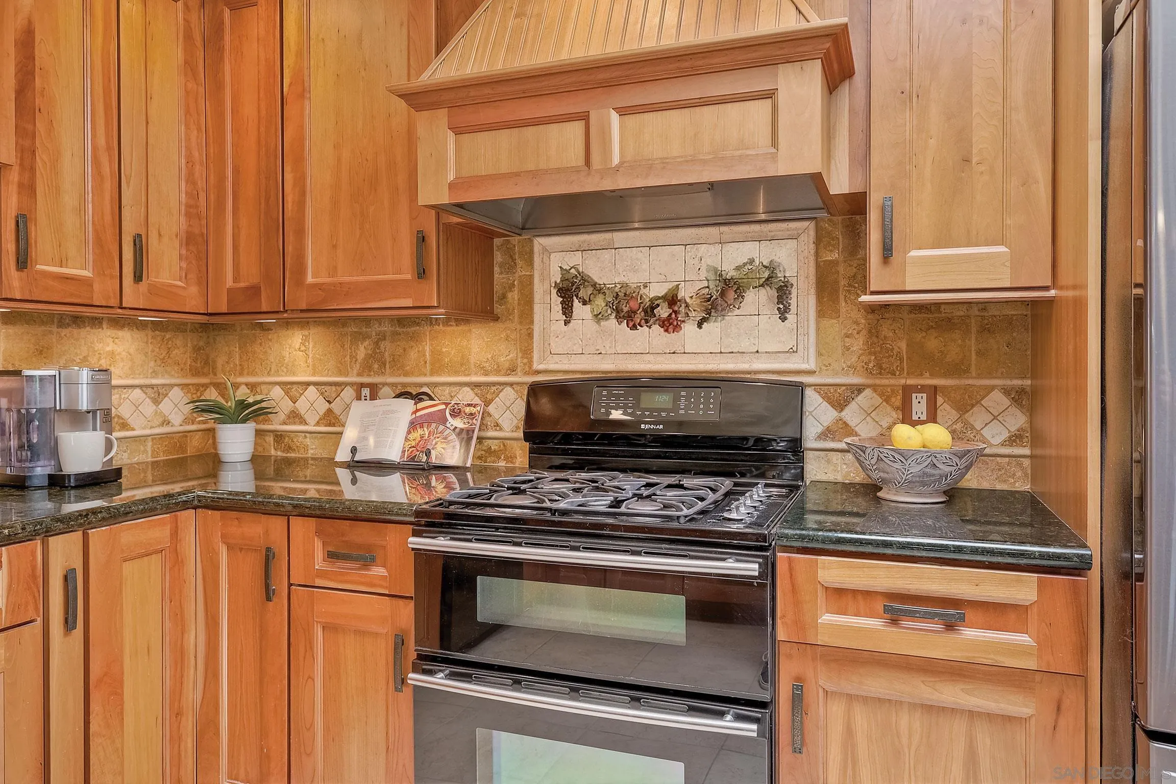 1996 Valley Rim Road El Cajon, CA 92019 - Photo 25 of 74 a kitchen with stainless steel appliances wooden cabinets and a stove top oven