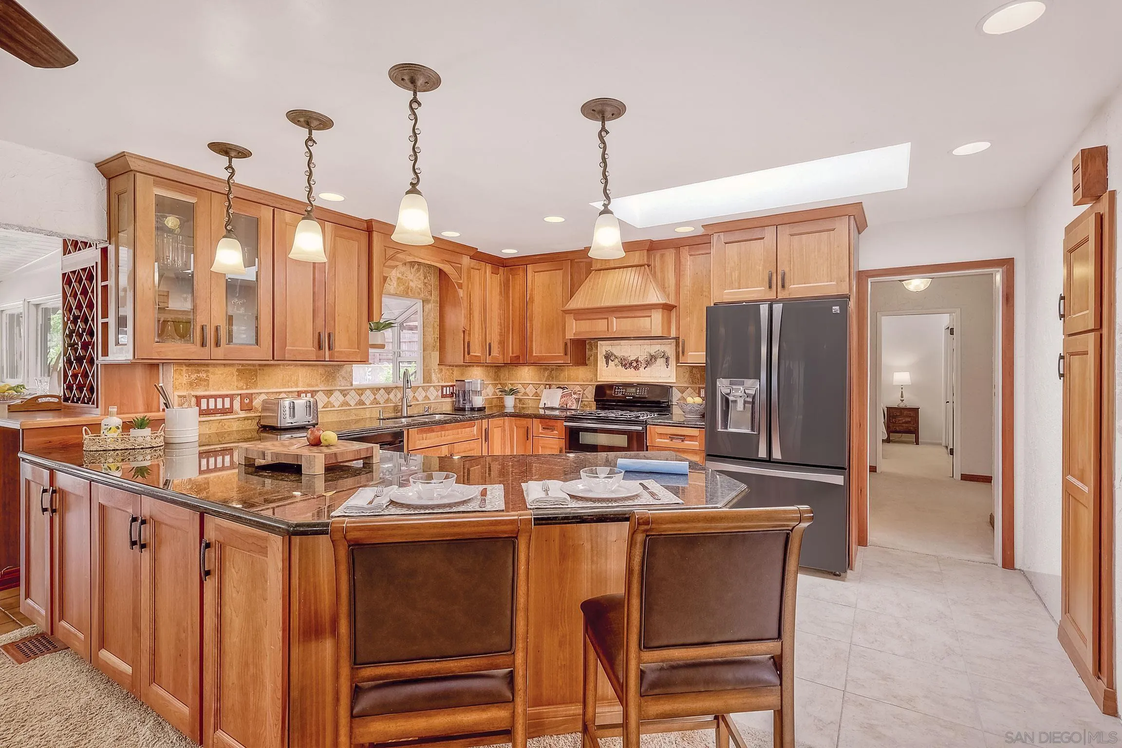 1996 Valley Rim Road El Cajon, CA 92019 - Photo 26 of 74 a kitchen with stainless steel appliances a sink a stove a refrigerator cabinets and chairs